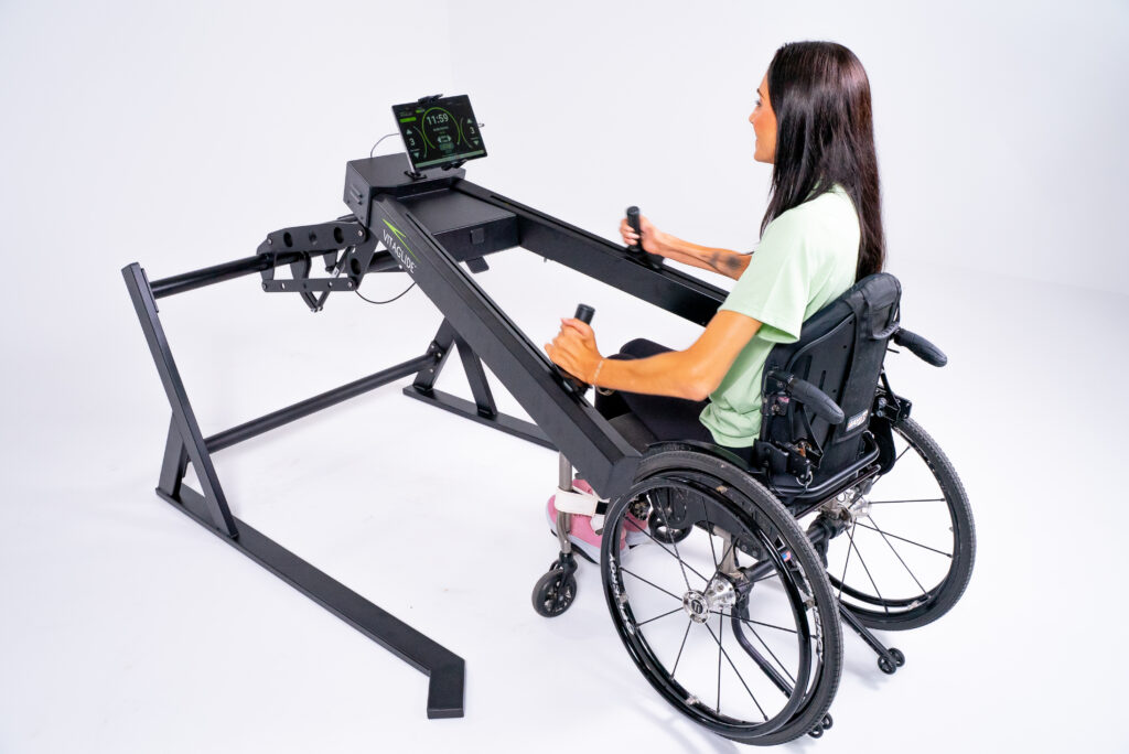 A woman uses a Vitaglide exercise system from her wheelchair.