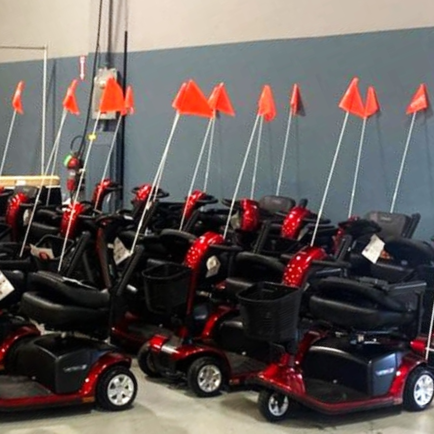 A small army of Pride Mobility loaner scooters wait for Abilities Expo attendees to check them our for use during the Expo.