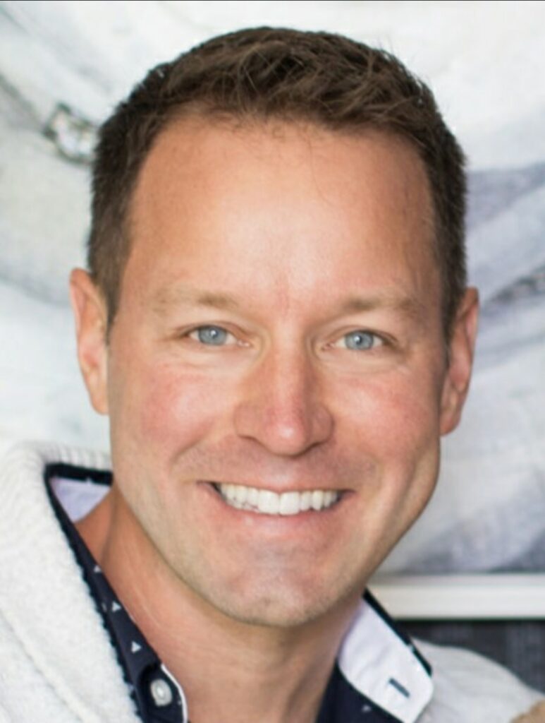 Headshop of a smiling Corey Welch
