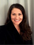 A woman, Andrea Lewis, smiles at the camera
