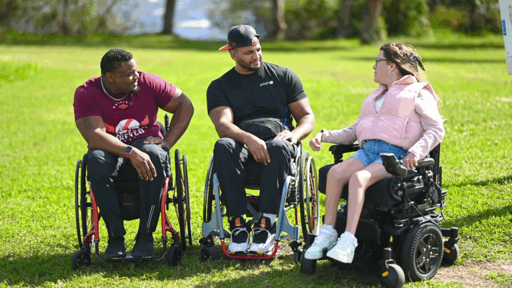 Two guys in namual chair are chatting with a woman in a power chair. They are all comfortable thanks to their Kalogon seating systems.