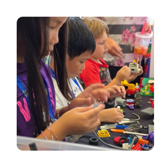 Kids building robotics in the Future Innovators Zone.