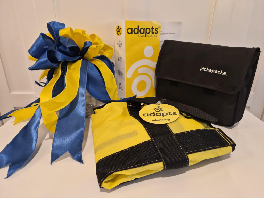 Adapts transfer sling and a pickepacke bag are shown with a blue and yellow ribbon