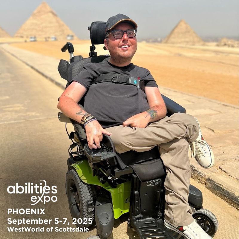 Accessible travel guru Cory Lee poses in Egypt with the pyramids in the background. It reads: 'abilities expo, Phoenix, September 5-7, 2025, Westworld of Phoenix.