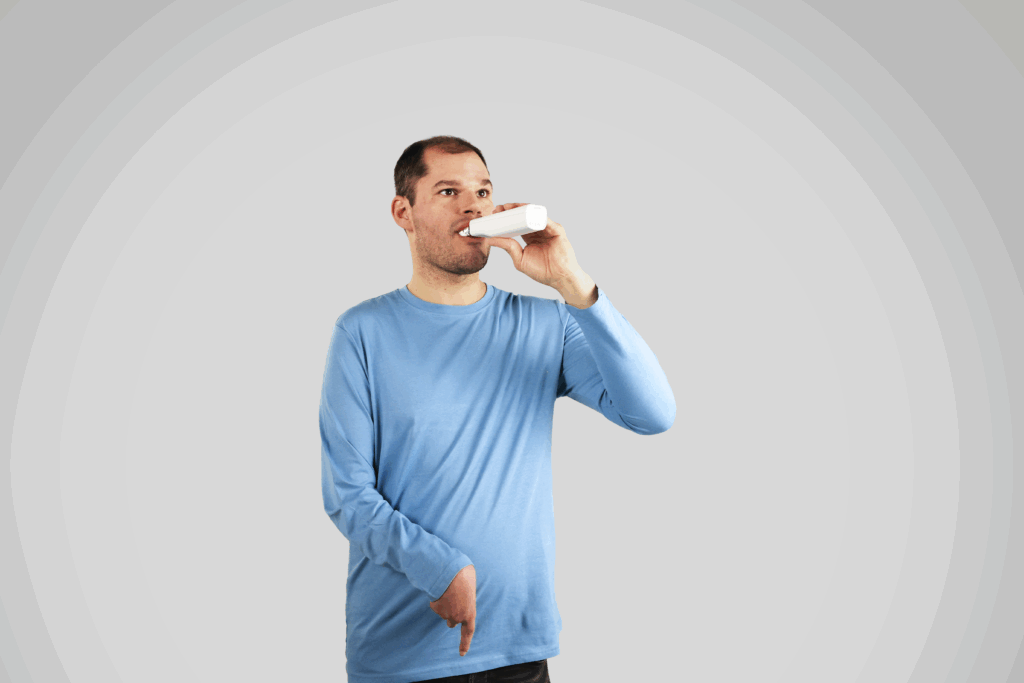 A man in a blue shirt using the Samba robotic toothbrush from Curaprox