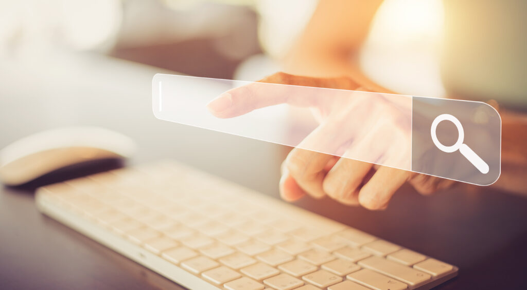 Picture of someones hands typing on a white keyboard