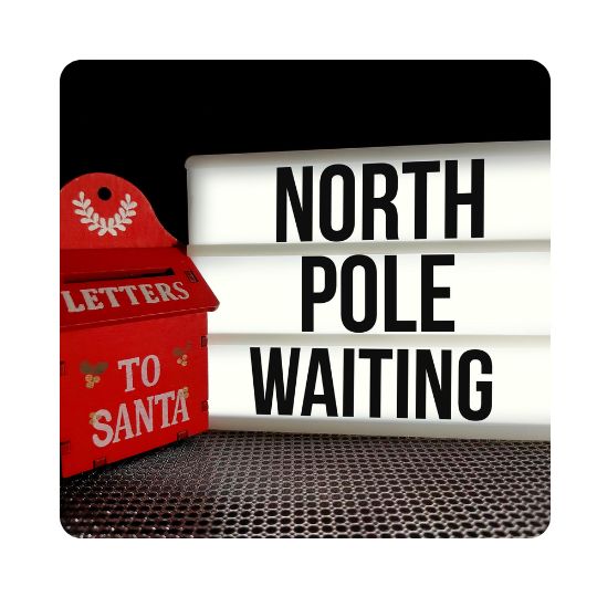 Photo of a red mailbox that says Letters to Santa. Next to that a sign says North Pole Waiting