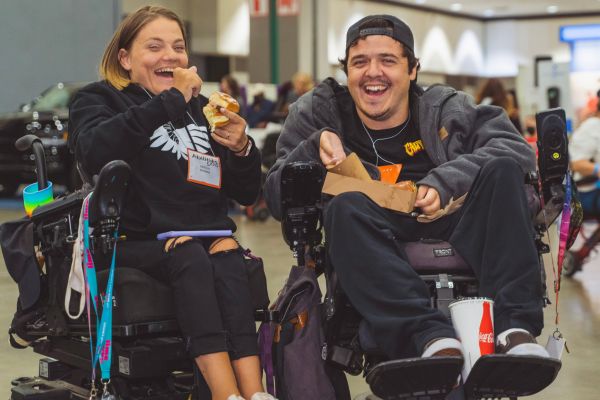 two Abilities Expo attendees smile together