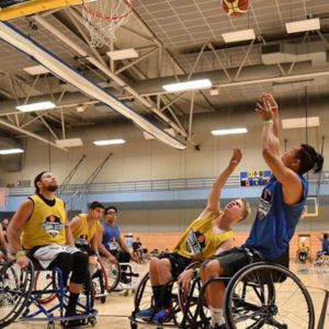 A group of men play wheelchair basketball