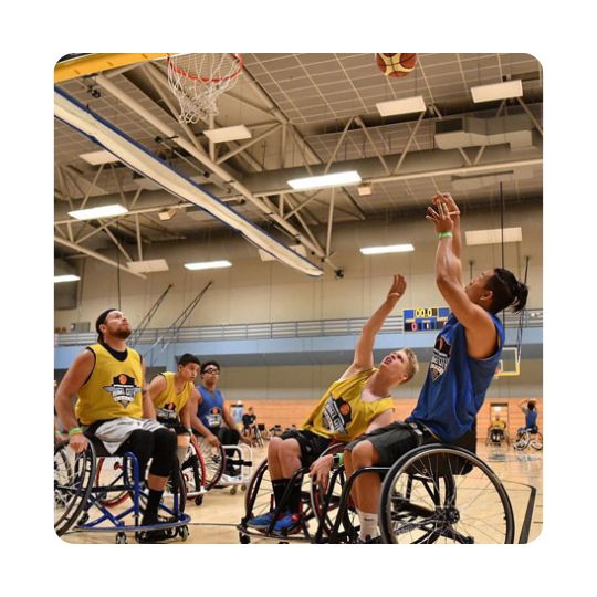 A group of men play wheelchair basketball