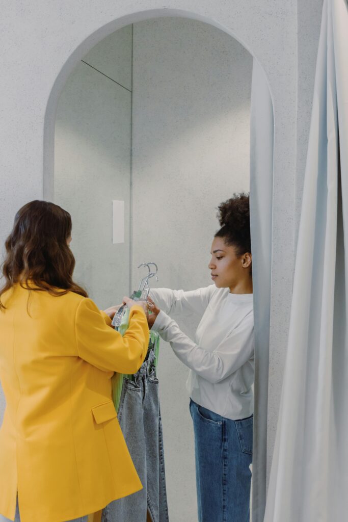 Women exchange clothes in a fitting room