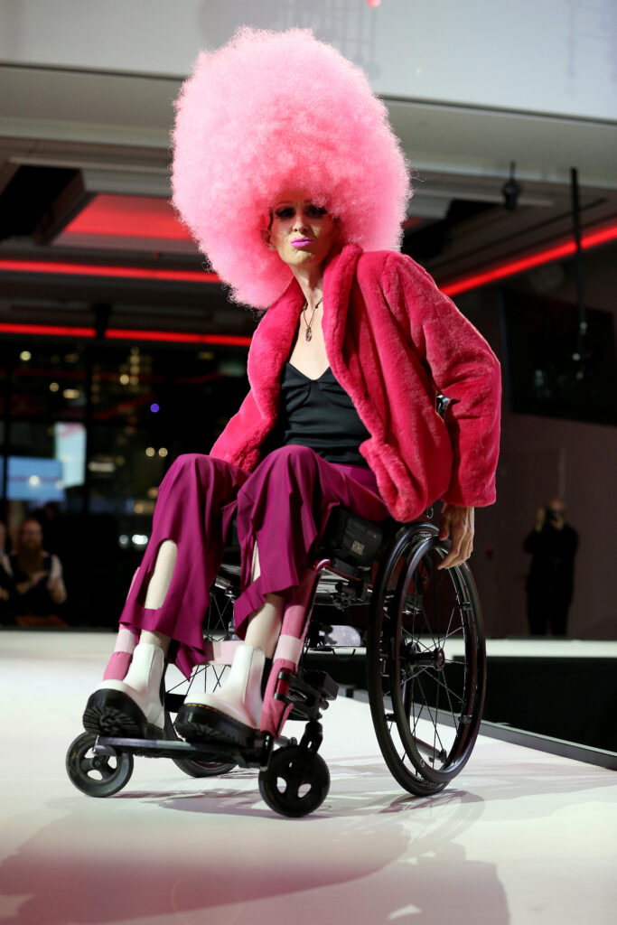Model with disabilities on the runway during a Runway of Dreams fashion show.