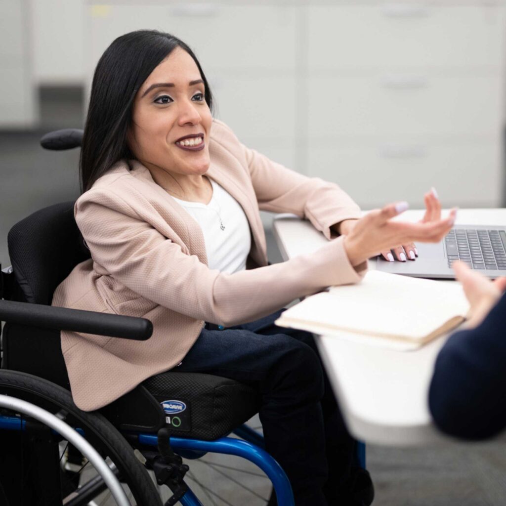 A woman in a wheelchair talking to someone