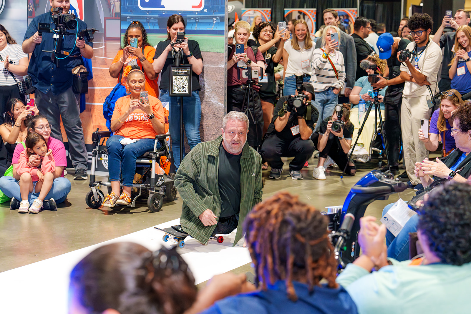 Dave Stevens models for a huge crown at the Runway of Dreams fashion show at Abilities Expo.