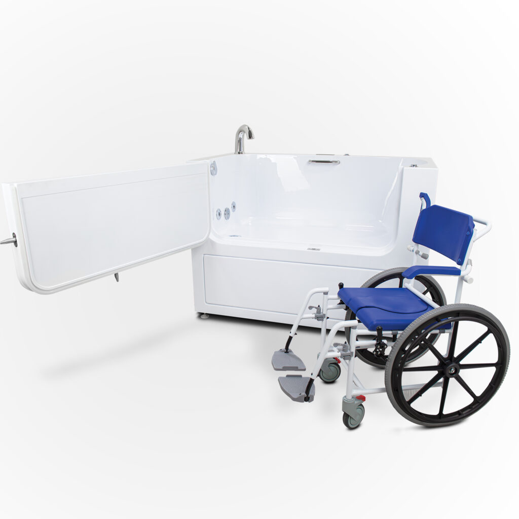 Ella’s Bubbles assisted walk-in bathtub with oversized outward-swing access door positioned beside a blue wheelchair against a white studio background.