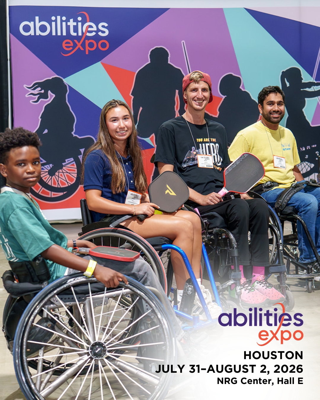 A group of people with adaptive pickleball rackets smile in front of an Abilities Expo sign. The bottom corner reads 'abilities expo Houston, July 31-august 2, 2026, NRG Center, Hall E.'