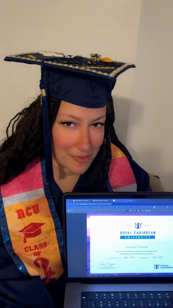 A photo of Yolanda Vicente in graduation robes for Royal Carribean University after graduating with honors
