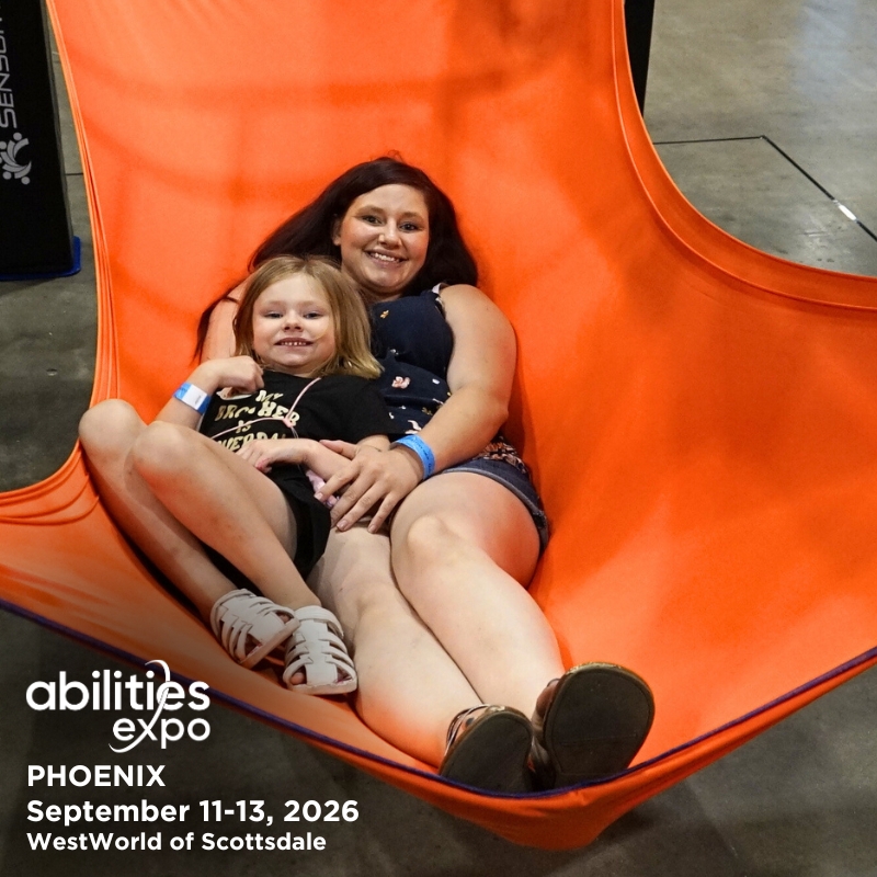 A mother and her daughter smile together while lounging in a sling. The bottom left corner reads "abilities expo Phoenix, September11-13, 2026, WestWorld of Scottsdale."
